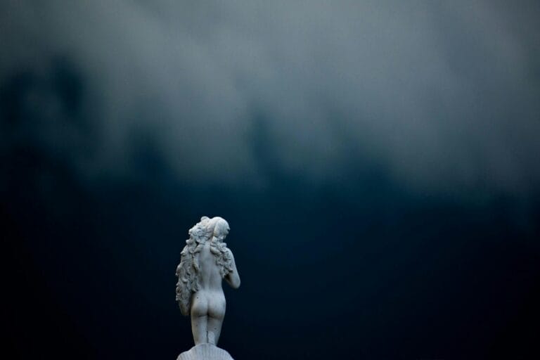 statue of woman in a darkness, symbolising her readoness to explore herself.